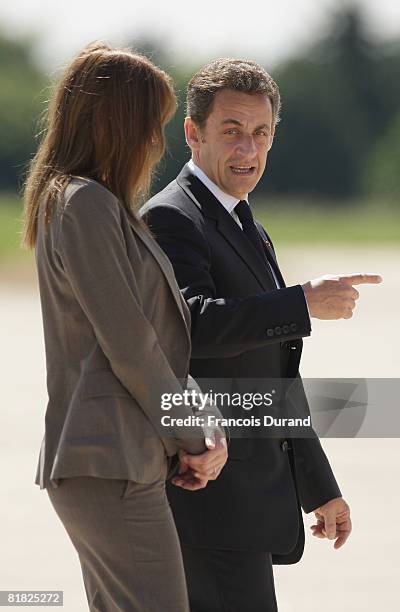 Carla Bruni-Sarkozy and French President Nicolas Sarkozy attend the arrival of Ingrid Betancourt at the military base of Villacoublay on July 4, 2008...