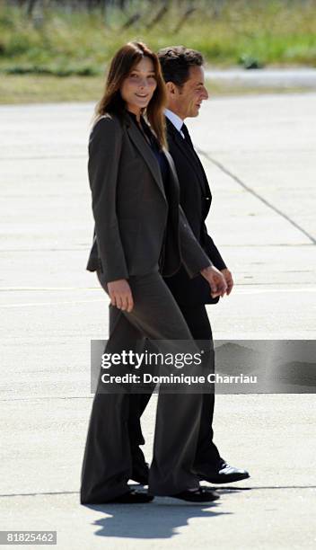 President Nicolas Sarkozy and first lady Carla Bruni-Sarkozy of France await the arrival by plane of freed hostage Ingrid Betancourt at the military...