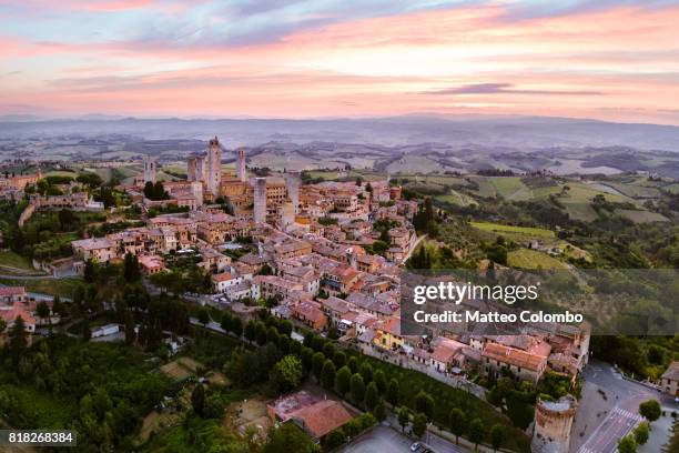 aerial drone view of san gimignano town at dawn, tuscany, italy - san gimignano stock-fotos und bilder