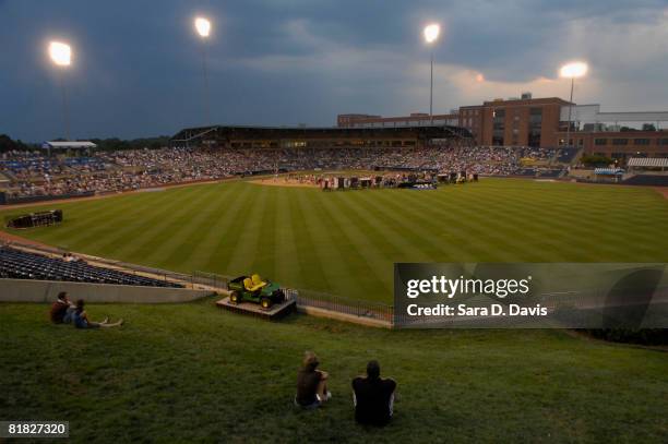 Fans watch Kevin Costner perform with his band Modern West during a July Fourth celebration at the Durham Bulls Athletic Park in Durham, North...