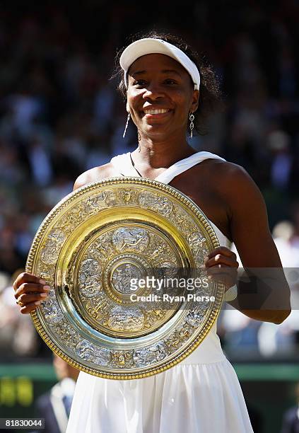 Venus Williams of United States celebrates winning the Championship trophy during the women's singles Final match against Serena Williams of United...