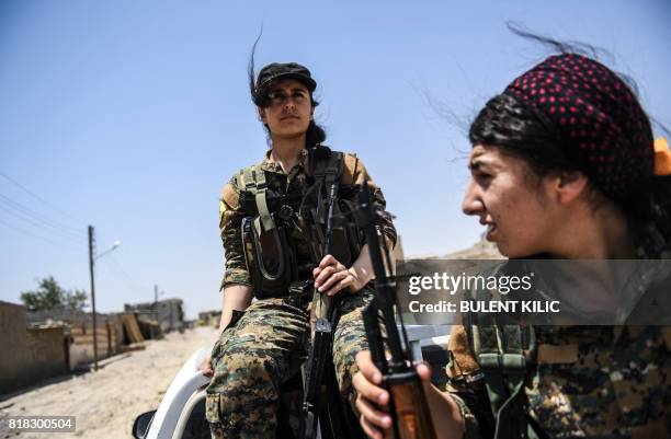 Members of the Women's Protection Units arrive on the frontline on the eastern outskirts of Raqa on July 18 during the ongoing offensive by the...