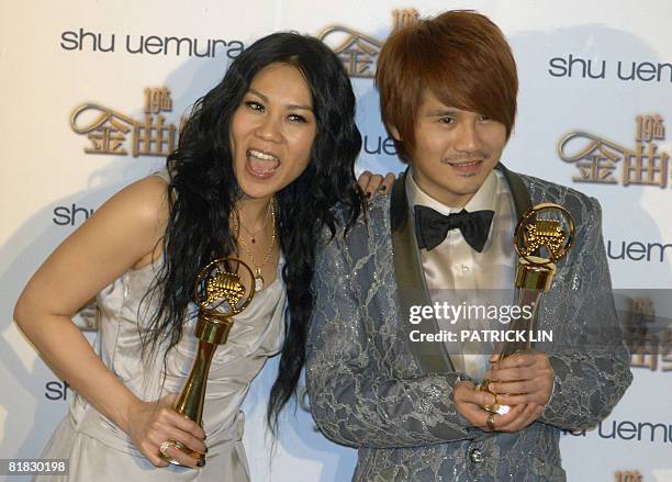Singaporean singer Tanya Chua and Malaysian singer Gary Cao display their trophies after winning the Best Female and Male Singer Awards during the...