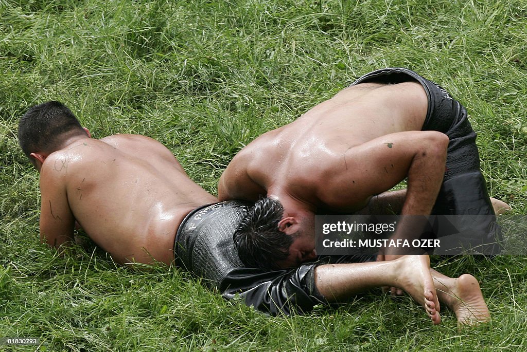 Turkish oil wrestlers fight during the K