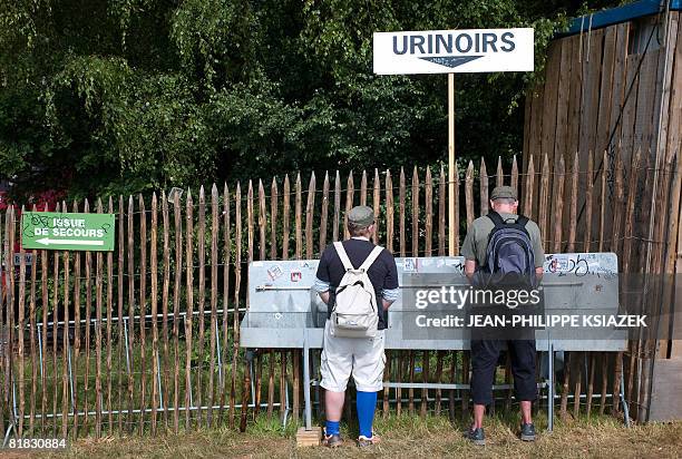 Two men urinate during the 20th edition of the French rock festival "Les eurockeennes de Belfort", on July 05, 2008 in Belfort, eastern France. The...