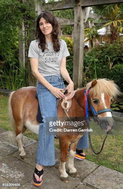 Bella Freud rides Freddie the Shetland pony at the J Brand x Bella Freud garden tea party on July 18, 2017 in London, England.
