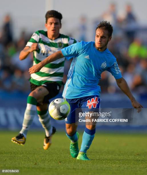 Olympique de Marseille's French midfielder Yusuf Sari vies with Sporting's Argentinian defender Jonathan Silva during a friendly football match...