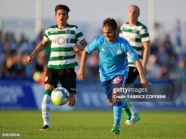 Olympique de Marseille's French midfielder Yusuf Sari vies with Sporting's Argentinian defender Jonathan Silva during a friendly football match...