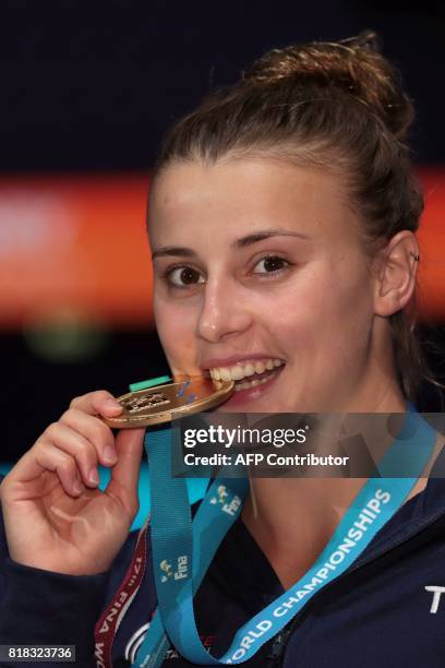 France's Laura Marino poses with her gold medal during the podium ceremony for the 3m/10m team event during the diving competition at the 2017 FINA...