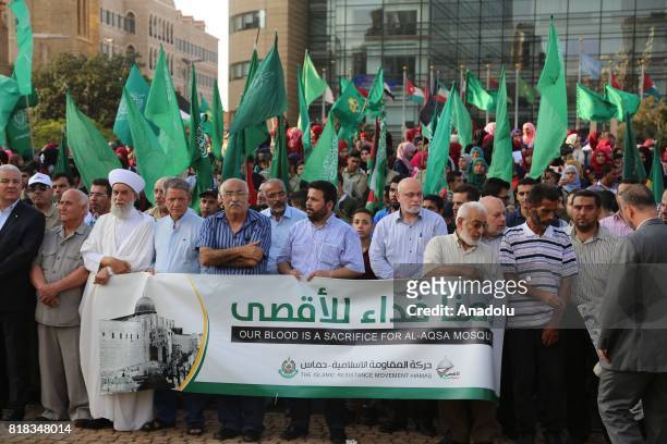 Lebanese and Palestinian people hold banners and flags as they stage a demonstration to protest the Israeli violations and restrictions against the...