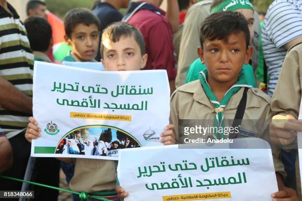 Lebanese and Palestinian kids hold banners as they stage a demonstration to protest the Israeli violations and restrictions against the Al-Aqsa...