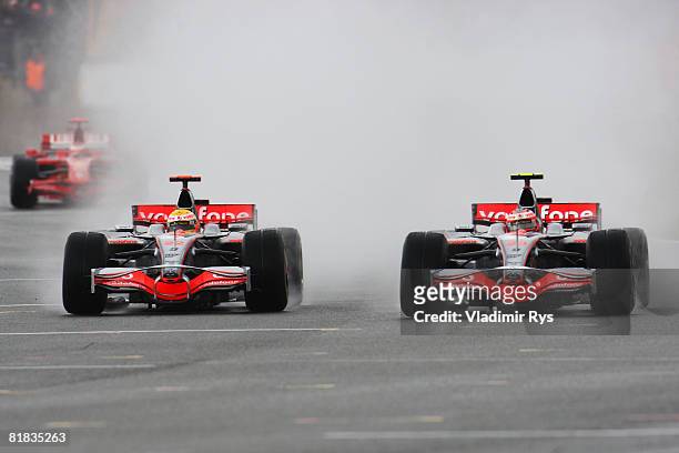 Lewis Hamilton of Great Britain and McLaren Mercedes side by side with team mate Heikki Kovalainen of Finland and McLaren Mercedes during the British...
