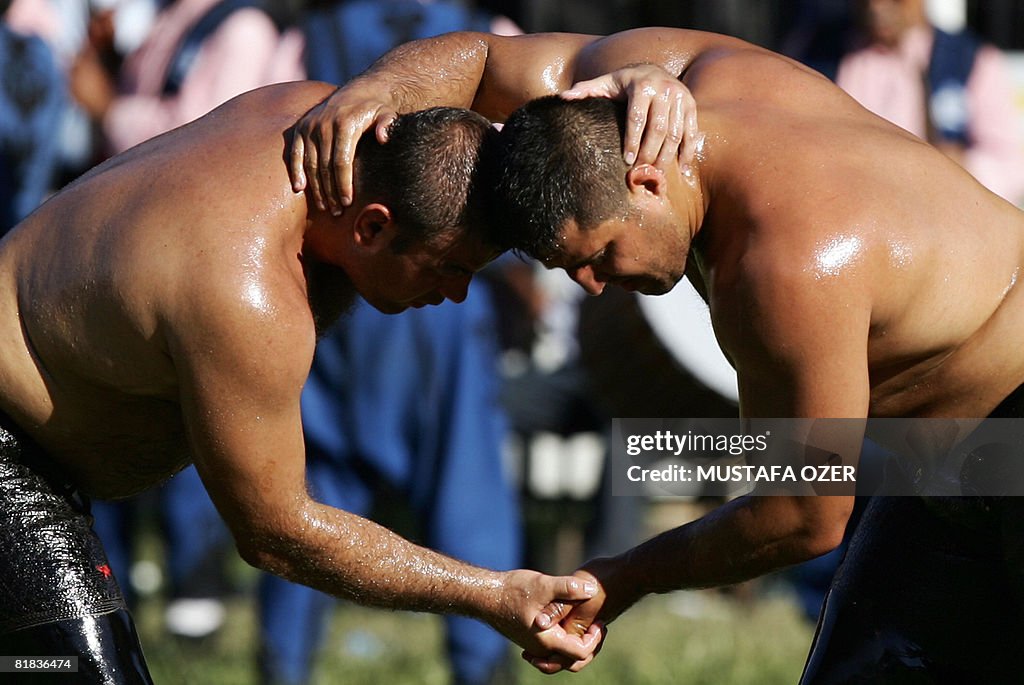 Turkish oil wrestlers Recep Kara (R) an