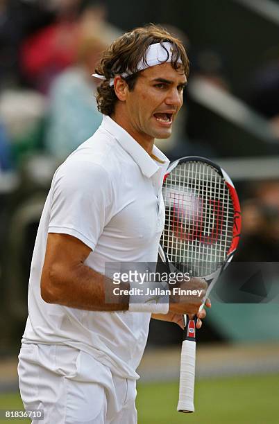 Roger Federer of Switzerland celebrates a point during the men's singles Final match against Rafael Nadal of Spain on day thirteen of the Wimbledon...