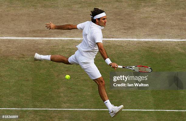 Roger Federer of Switzerland plays a backhand during the men's singles Final match against Rafael Nadal of Spain on day thirteen of the Wimbledon...