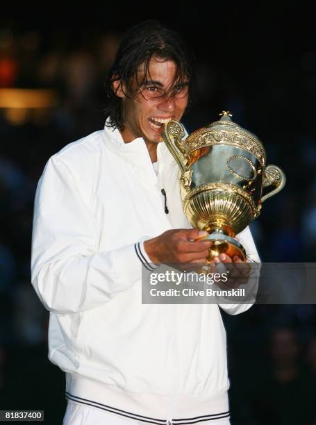 Rafael Nadal of Spain celebrates with the trophy winning the Championship during the men's singles Final match against Roger Federer of Switzerland...