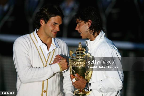 Roger Federer of Switzerland congratulates Rafael Nadal of Spain in winning the Championship trophy during the men's singles Final on day thirteen of...