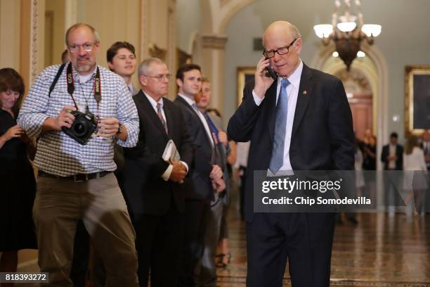 Sen. Pat Roberts pretends to talk to President Donald Trump on the phone following the weekly Senate Republican policy luncheon at the U.S. Capitol...