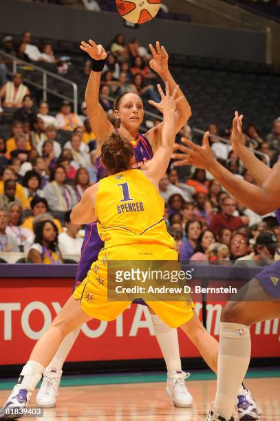 Diana Taurasi of the Phoenix Mercury passes over the head of Sidney Spencer of the Los Angeles Sparks during the game on July 6, 2008 at Staples...