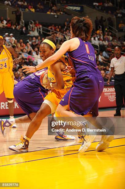 Temeka Johnson of the Los Angeles Sparks drives the ball during the game against Yuko Oga of the Phoenix Mercury on July 6, 2008 at Staples Center in...