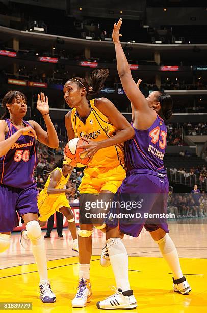 Lisa Leslie of the Los Angeles Sparks goes up for a shot as Tangela Smith and Le'Coe Willingham of the Phoenix Mercury defend on July 6, 2008 at...