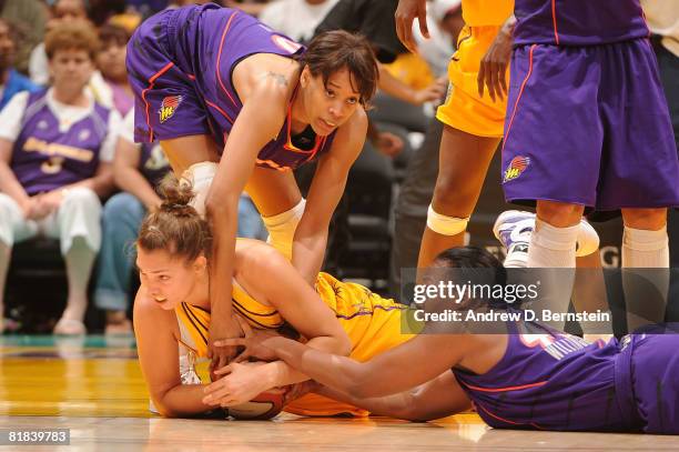 Sidney Spencer of the Los Angeles Sparks fights for the ball during the game against Le'Coe Willingham and Tangela Smith of the Phoenix Mercury on...