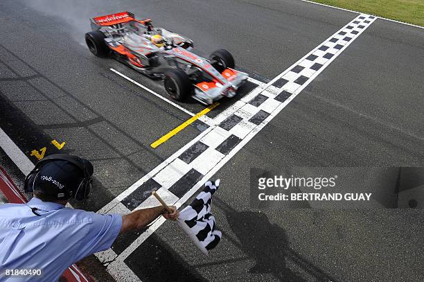McLaren Mercedes' British driver Lewis Hamilton crosses the finish line at the Silverstone racetrack on July 6, 2008 in Silverstone, England, during...