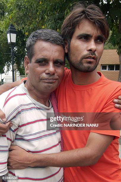 Released Indian prisoner Ram Prakash is hugged by his son Deepak as he crosses The India-Pakistan Border at Wagah on July 7, 2008. Prakash, freed...