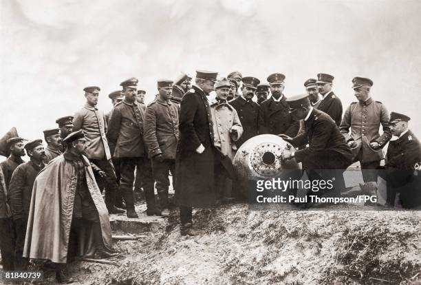 Count Posadowsky, Commander of the German Weichsel fleet, inspects a Russian floating mine recovered from the Vistula River during World War I, circa...
