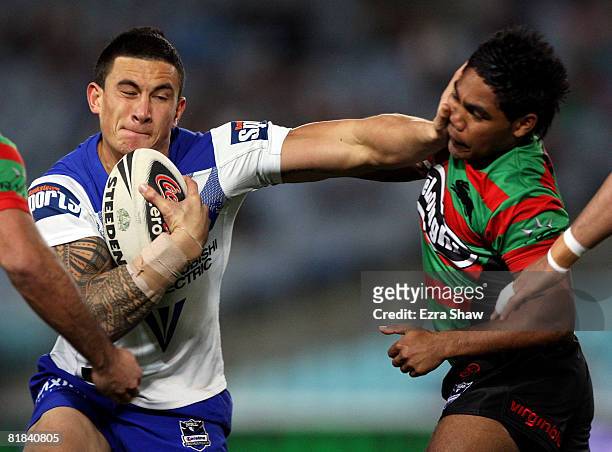 Sonny Bill Williams of the Bulldogs straight arms Chris Sandow of the Rabbitohs during the round 17 NRL match between the Bulldogs and the South...