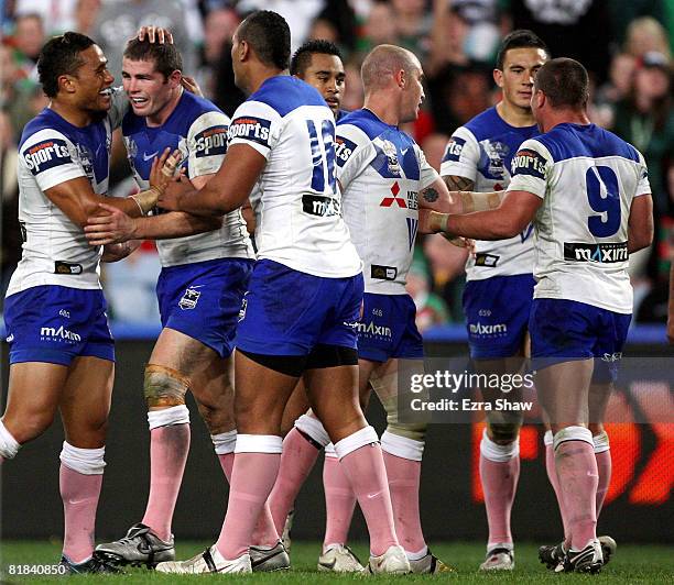 Andrew Ryan of the Bulldogs is congratulated by teammates after scoring a try during the round 17 NRL match between the Bulldogs and the South Sydney...