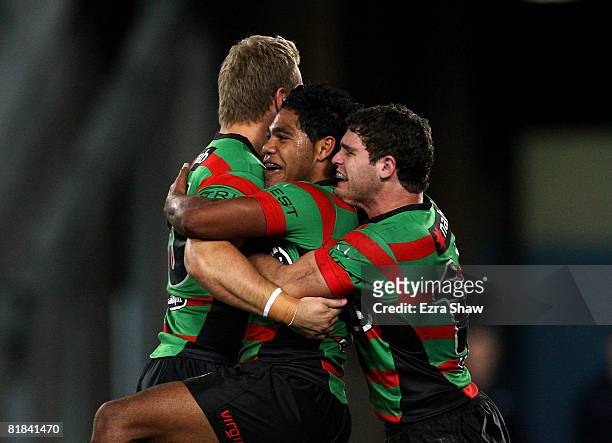 Chris Sandow of the Rabbitohs is congratulated by Beau Falloon and Shannan McPherson after he scored a try during the round 17 NRL match between the...