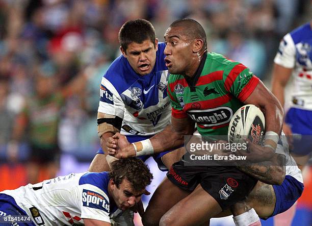 Manase Manuokafoa of the Rabbitohs is tackled during the round 17 NRL match between the Bulldogs and the South Sydney Rabbitohs at ANZ Stadium on...