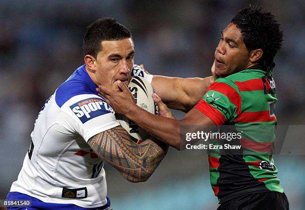 Sonny Bill Williams of the Bulldogs gets tangled up with Chris Sandow of the Rabbitohs during the round 17 NRL match between the Bulldogs and the...