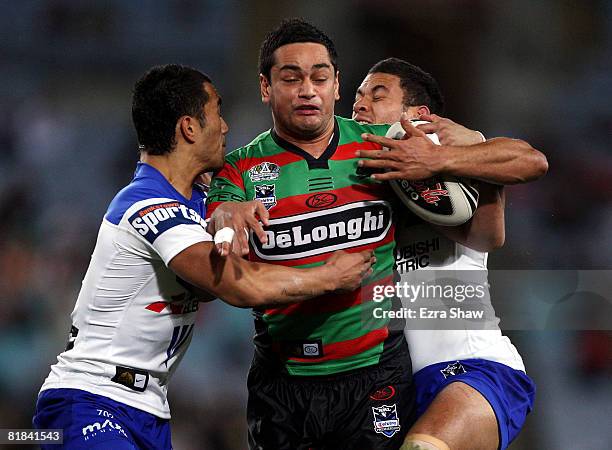 John Sutton of the Rabbitohs is tackled during the round 17 NRL match between the Bulldogs and the South Sydney Rabbitohs at ANZ Stadium on July 7,...