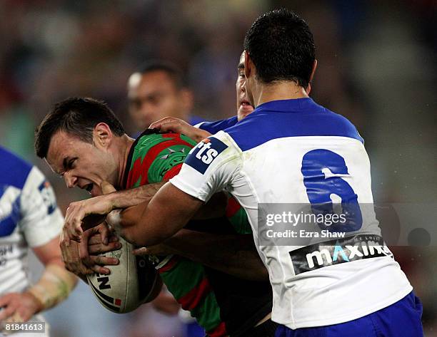 Beau Champion of the Rabbitohs is tackled during the round 17 NRL match between the Bulldogs and the South Sydney Rabbitohs at ANZ Stadium on July 7,...