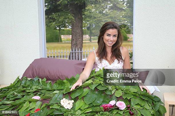 Model poses in an edible bed during the Hampton Court Palace Flower Show on July 7, 2008 in Richmond-upon-Thames, England.