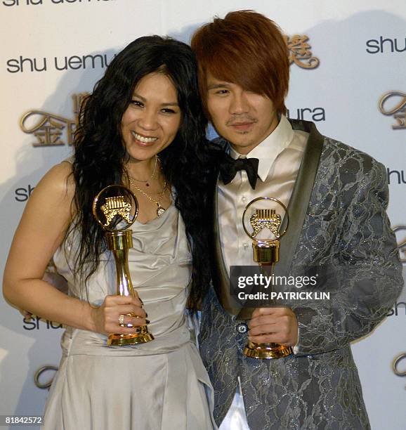 Singaporean singer Tanya Chua and Malaysian singer Gary Cao display their trophies after winning the Best Female and Male Singer Awards during the...