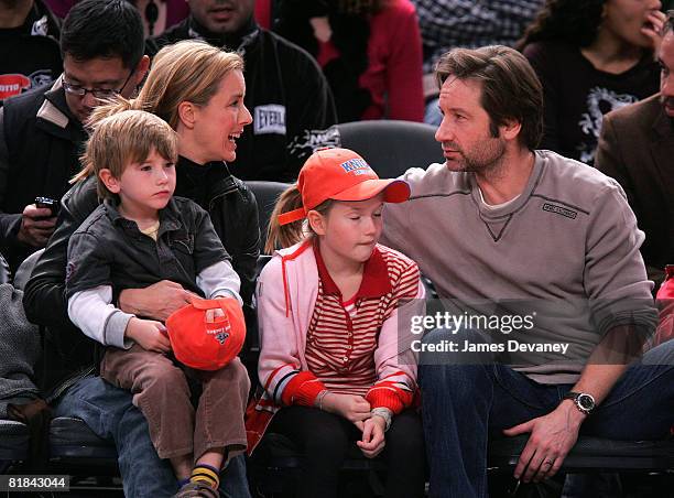 A Leoni and David Duchovny with their children attend Minnesota Timberwolves vs NY Knicks basketball game at Madison Square Garden in New York City...