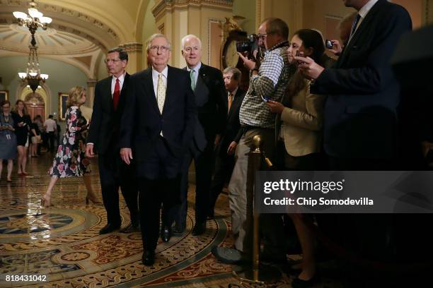 Sen. John Barrasso , Senate Majority Leader Mitch McConnell and Senate Majority Whip John Cornyn prepare to speak to reporters following the weekly...