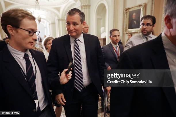 Sen. Ted Cruz talks with reporters before attending the weekly Senate Republican policy luncheon outside the Mansfield Room at the U.S. Capitol July...