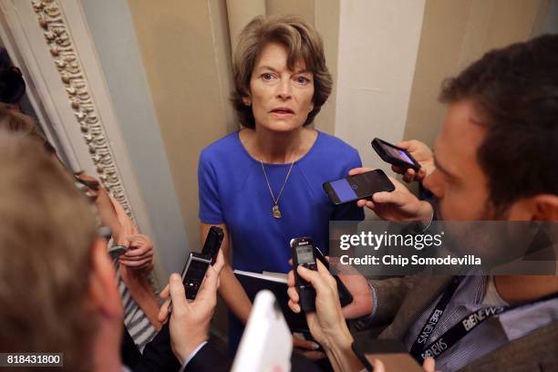 Sen. Lisa Murkowski talks with reporters before attending the weekly Senate Republican policy luncheon outside the Mansfield Room at the U.S. Capitol...