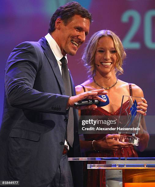 Kick boxing world champion Christine Theiss receives the Bavarian Sport Award 2008 from actor Ralf Moeller at the International Congress Center...