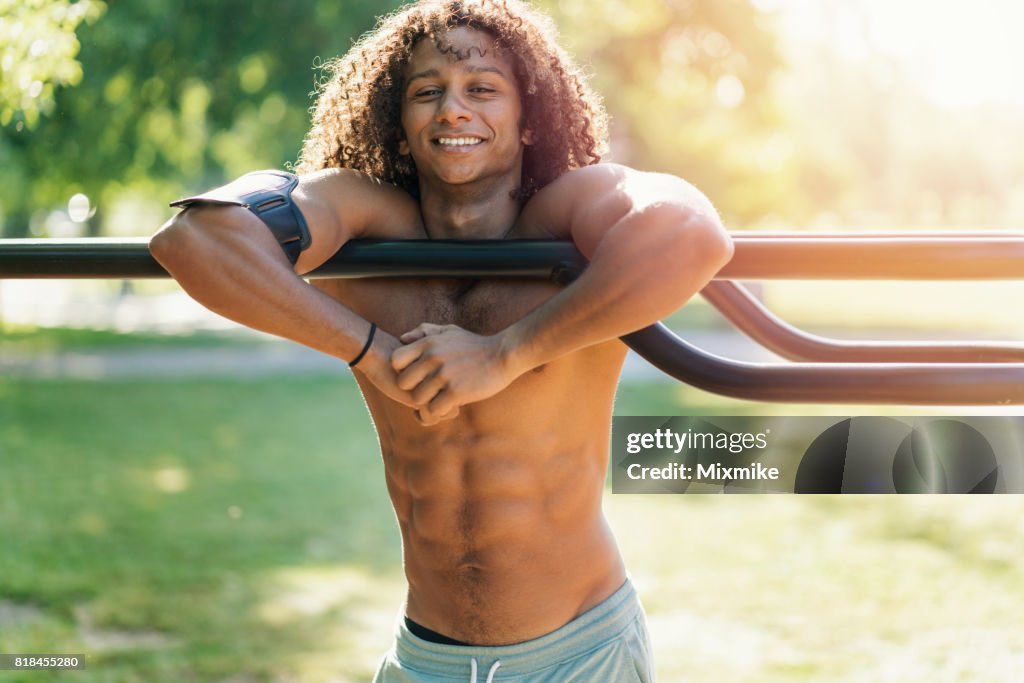Man showing his belly muscles and smiling