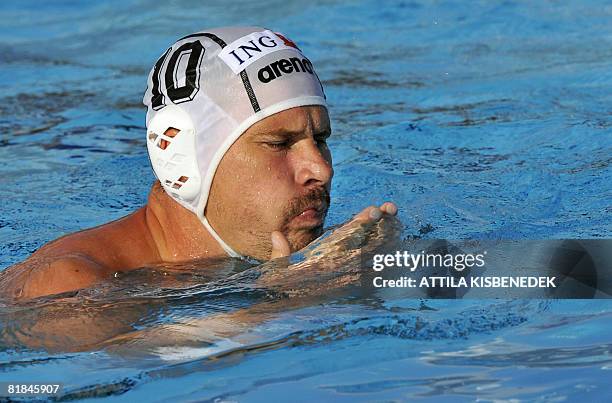 Hungarian Peter Biros checks his beaten face in the aquatic centre swimming pool of Spanish seaside town, Malaga on July 7, 2008 during a group match...