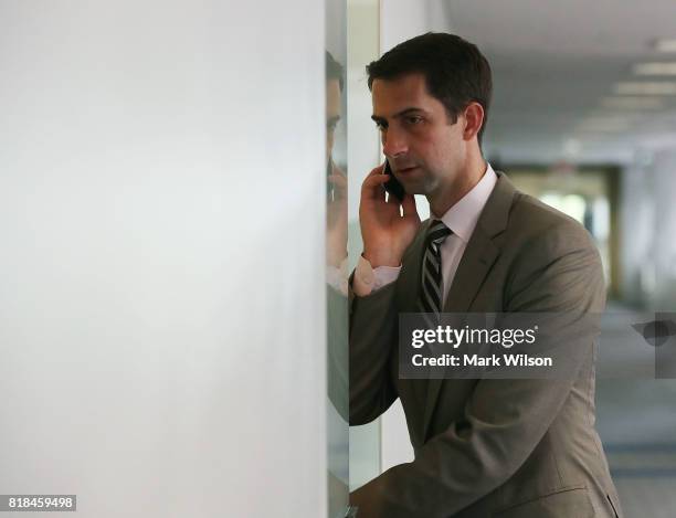 Sen. Tom Cotton , talks on his phone as he walks into a closed committee meeting on Capitol Hill July 18, 2017 in Washington, DC. The committee is...