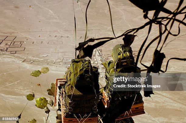 bundles of humanitarian supplies dropping from a c-17 globemaster. - troposphere stock pictures, royalty-free photos & images