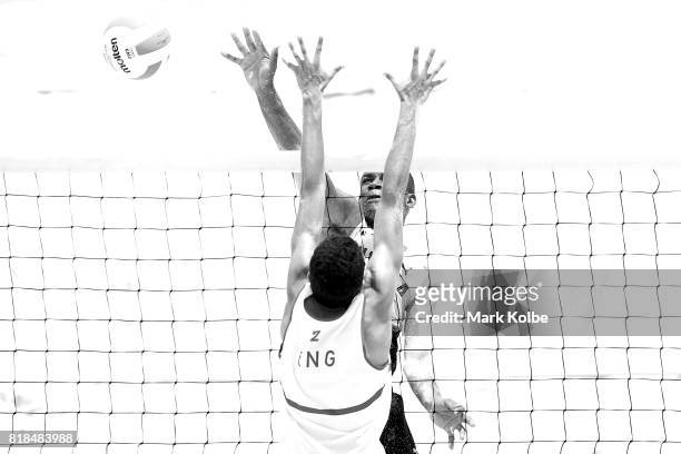 Javarie James of Jamaica spikes over Joaquin Bello of England as they compete in the Boys Beach Volleyball on day 1 of the 2017 Youth Commonwealth...