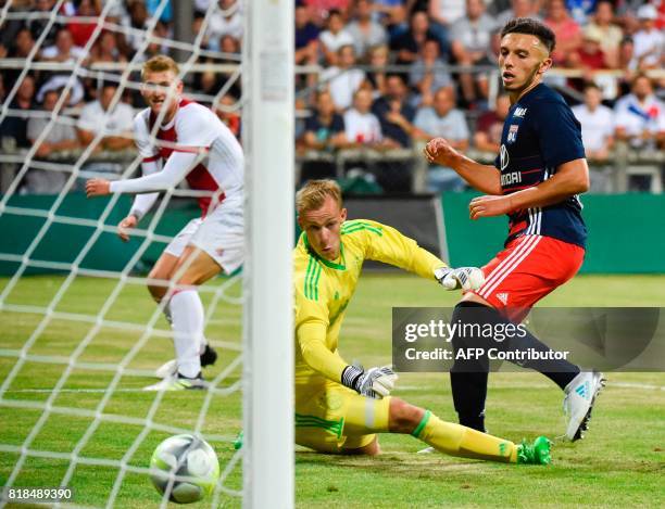 Lyon's forward Amine Gouiri scores his team's second goal past Ajax goalkeeper Stan van Bladeren during a friendly football match between Olympique...