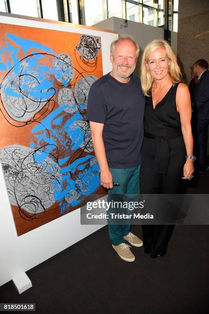 Judith Milberg and her husband Axel Milberg in front of one of her paintings during her exhibition opening 'Judith Milberg: Aus der Mitte' at...